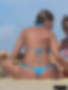 Sexy lady on the beach in a blue thong bikini