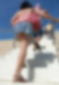 Girl upskirted while walking up stairs at the beach