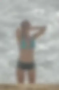 Blonde lady on the beach in bikini top and spandex shorts with a nice gap