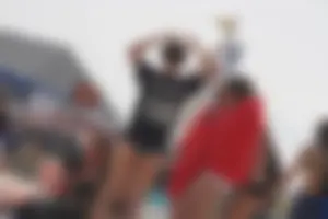 A group of teens in bikinis on the beach