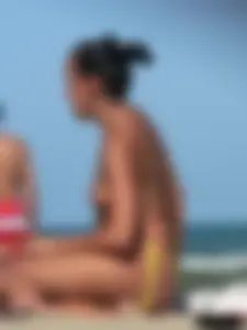 Bunch of sexy babes on the beach topless and in thong bikinis