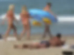 Sexy mom and daughter in red thongs at the beach