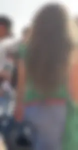 Booty in tight blue jeans, creepshot of a young girl with long wavy hair