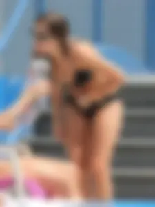 Sexy girl at the pool in a black bikini with nice body