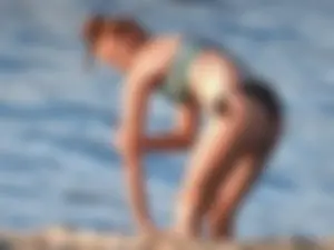Sexy beach girl in a Nike sports bra and black bikini bottom