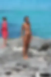 Older lady on a nude beach showing her body