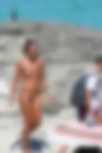 Older lady on a nude beach showing her body