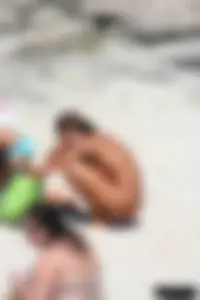 Older lady on a nude beach showing her body