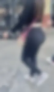 Latina BBL adjusting her leggings