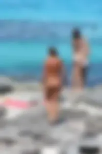 Older lady on a nude beach showing her body