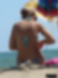 A bunch of hot babes on the beach in thong bikinis