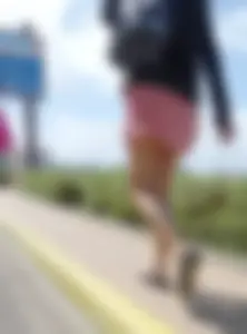 Blonde walking in short skirt shows a bit of her ass cheeks