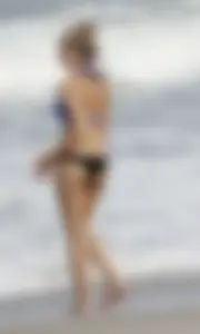Florida blonde in blue and black bikini on the beach