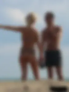 Tattooed blonde with big tits topless and in thong