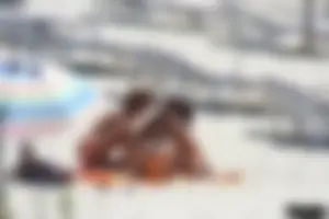Topless milf and her topless daughter on the beach