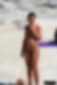 Smoking milf at a nude beach with a hairy pussy