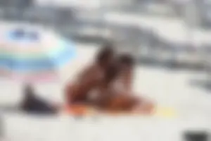 Topless milf and her topless daughter on the beach