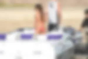 Brunette on a boat in red thong bikini with a tight little ass