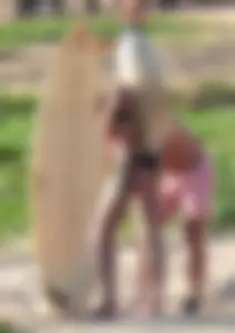 A sexy brunette and sexy blonde in bikinis at the beach