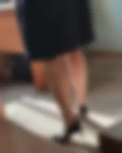 Hot teacher wearing stiletto heels and a skirt in classroom