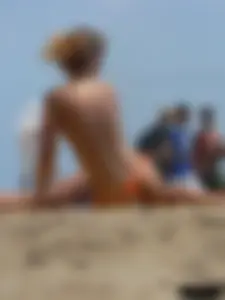 Two topless friends on the beach with nice boobs