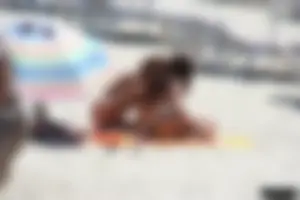 Topless milf and her topless daughter on the beach