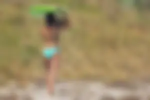Candid girls surfing on the beach