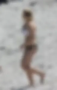 Big boobed thick blonde on the beach in a bikini
