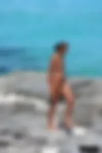 Older lady on a nude beach showing her body