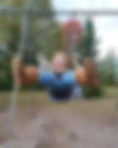 Non-candid teen in jeans on a swing