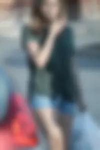 Cutie walking in the parking lot in jean shorts