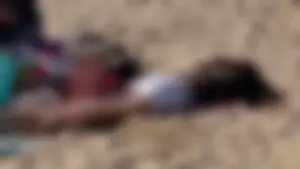 Beautiful Teen with Miniskirt resting on the beach