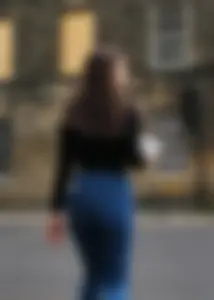 Brunette beauty with a slender waist in tight jeans