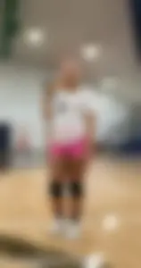 Bunch of cute college girls in bright pink shorts playing volleyball