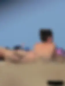 Sexy babe with a nice body topless and in a thong on the beach