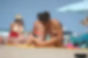 2 topless girls at the beach in thongs
