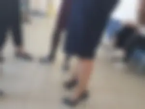 Legs of a Group of College Girls Standing in a Corridor
