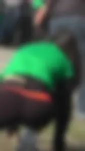 Sexy brunette in see thru leggings stretching before a run with a green thong