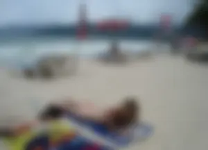Micro thong blonde on the beach with pokies and camel toe