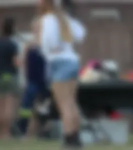 Hippie type dressed girl in denim shorts with a nice ass