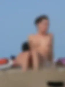 Sexy babe with a nice body topless and in a thong on the beach