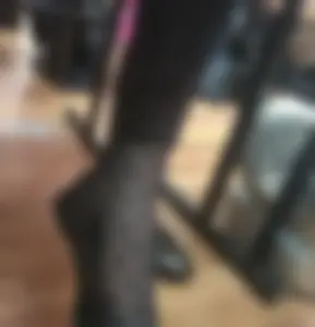 Feet in Flats and Black Pantyhose With Hearts Pattern Closeup in College Classroom
