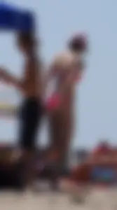 Sexy and skinny girl on the beach in pink bikini