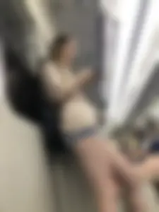 Tall Girl in Denim Mini Shorts and Sneakers With Long Pale Legs in a Subway Train