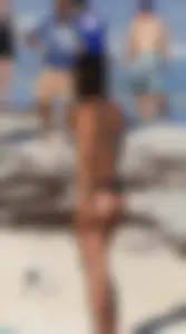 Tattooed beach babe in black thong with a nice ass