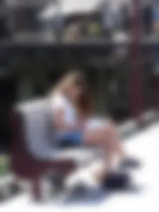 Pretty girl with a camera in little denim shorts