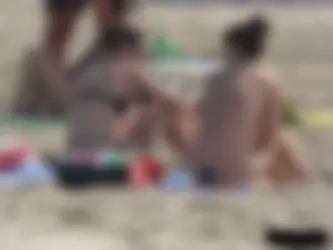 Sexy babe with a nice body topless and in a thong on the beach