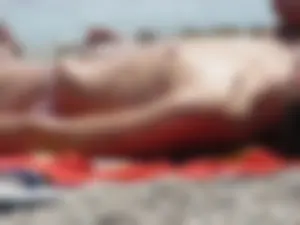Sexy topless girl on the beach in a thong bikini