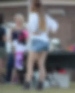 Hippie type dressed girl in denim shorts with a nice ass