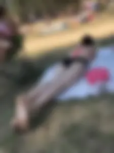 Pale Skinny Girl Lying on the Beach in Swimsuit With Crossed Legs Candid Gallery